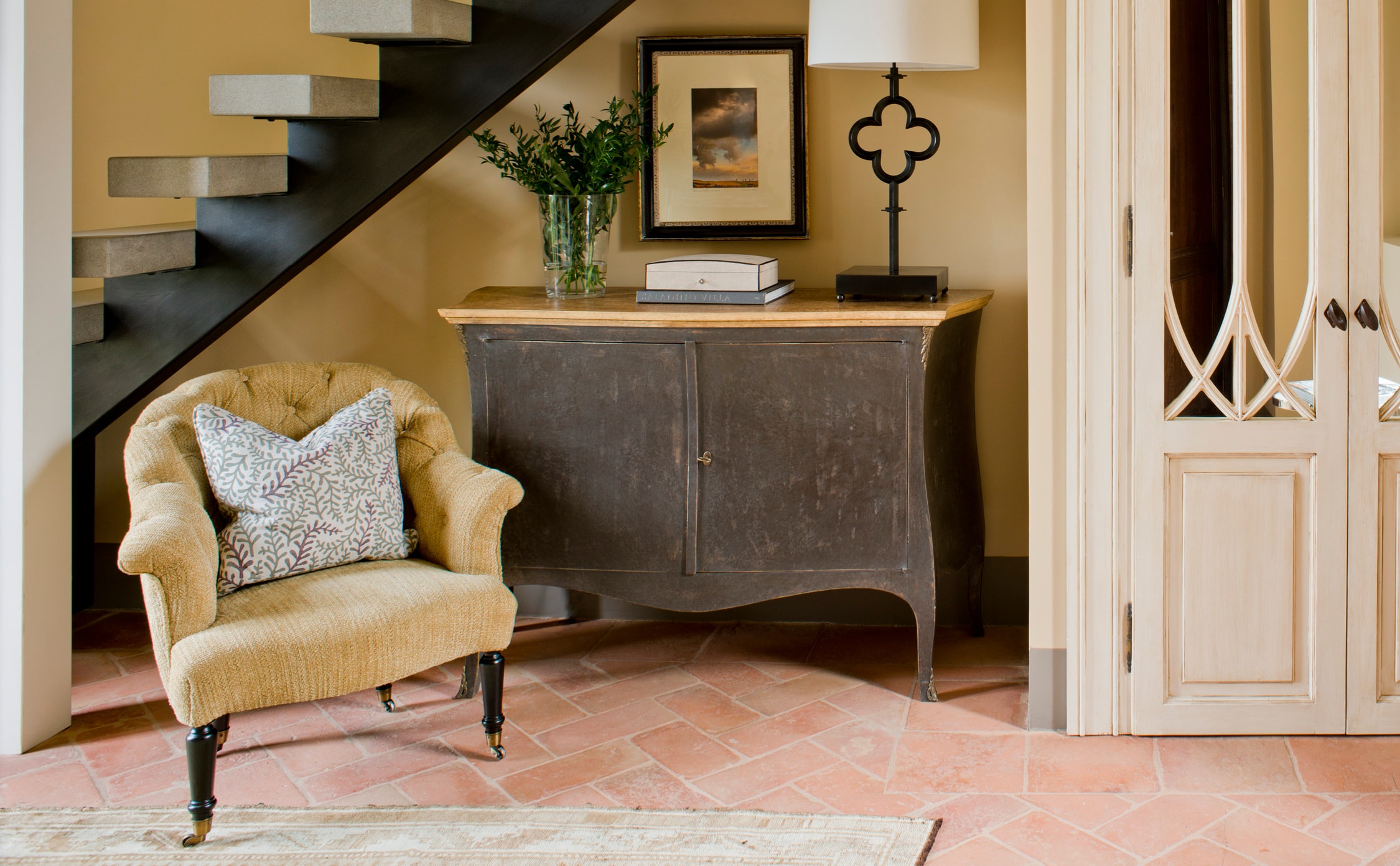 this tuscan foyer design by the j banks design group has material choices and colors that reflect the surrounding landscapes