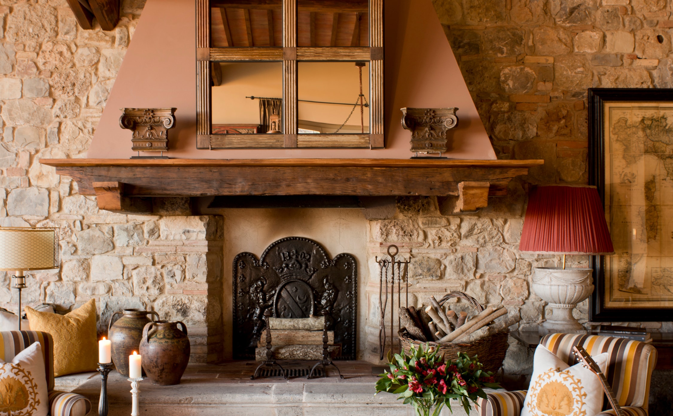 italian stonework on the fireplace in this living room by j banks design reflects the surrounding tuscan landscape