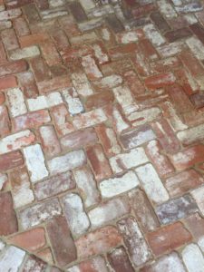 reclaimed brick flooring in the interior of the Ohoopee Match Club resort by j banks design group