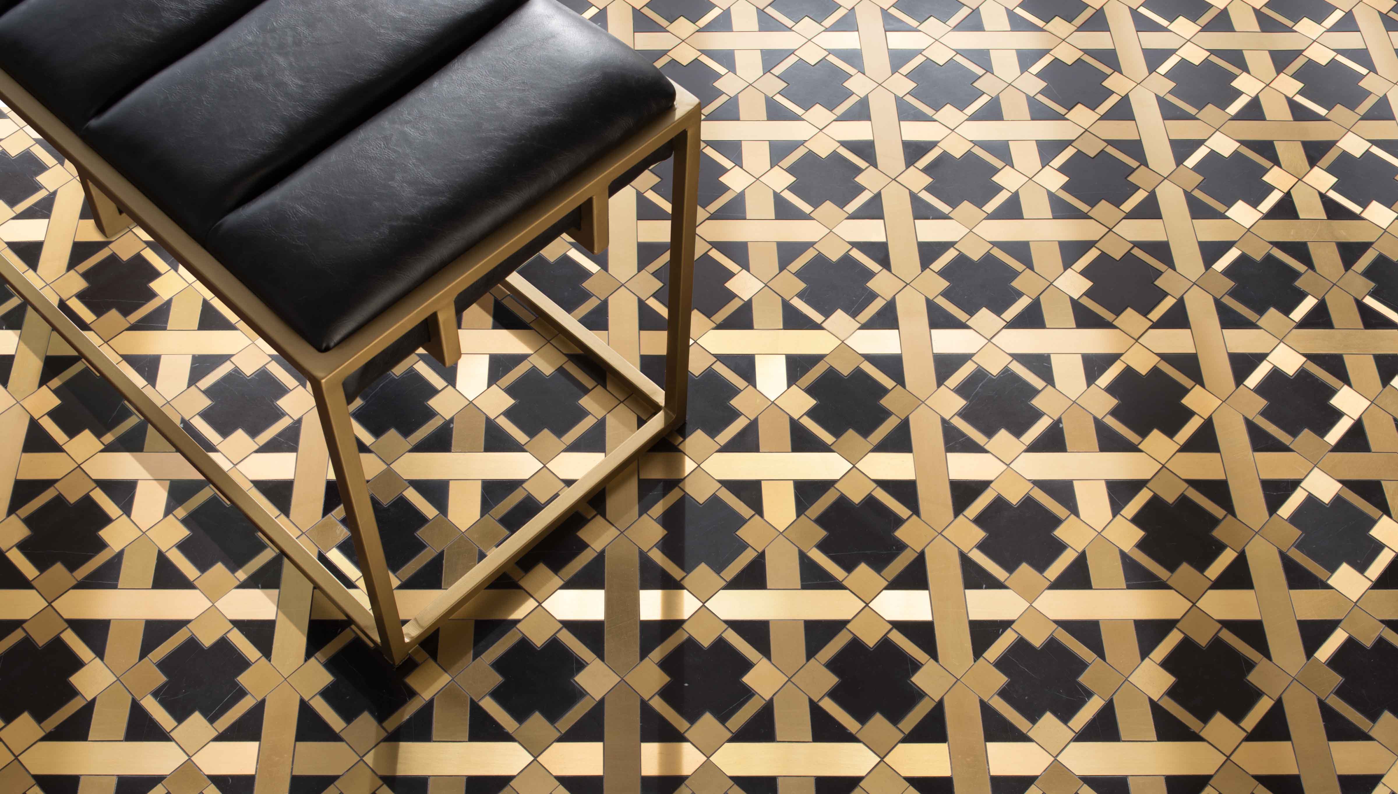 Kubuni stone mosaic shown in honed Nero Marquina and brass designed by Joni Vanderslice for New Ravenna