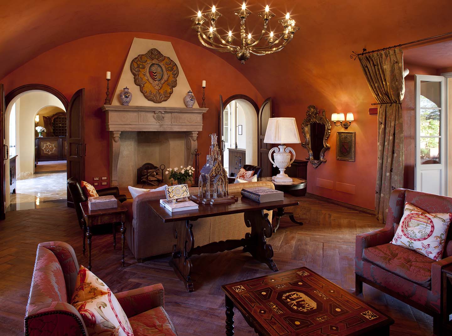 castello di casole lobby with a grandly scaled fireplace and sienna hues