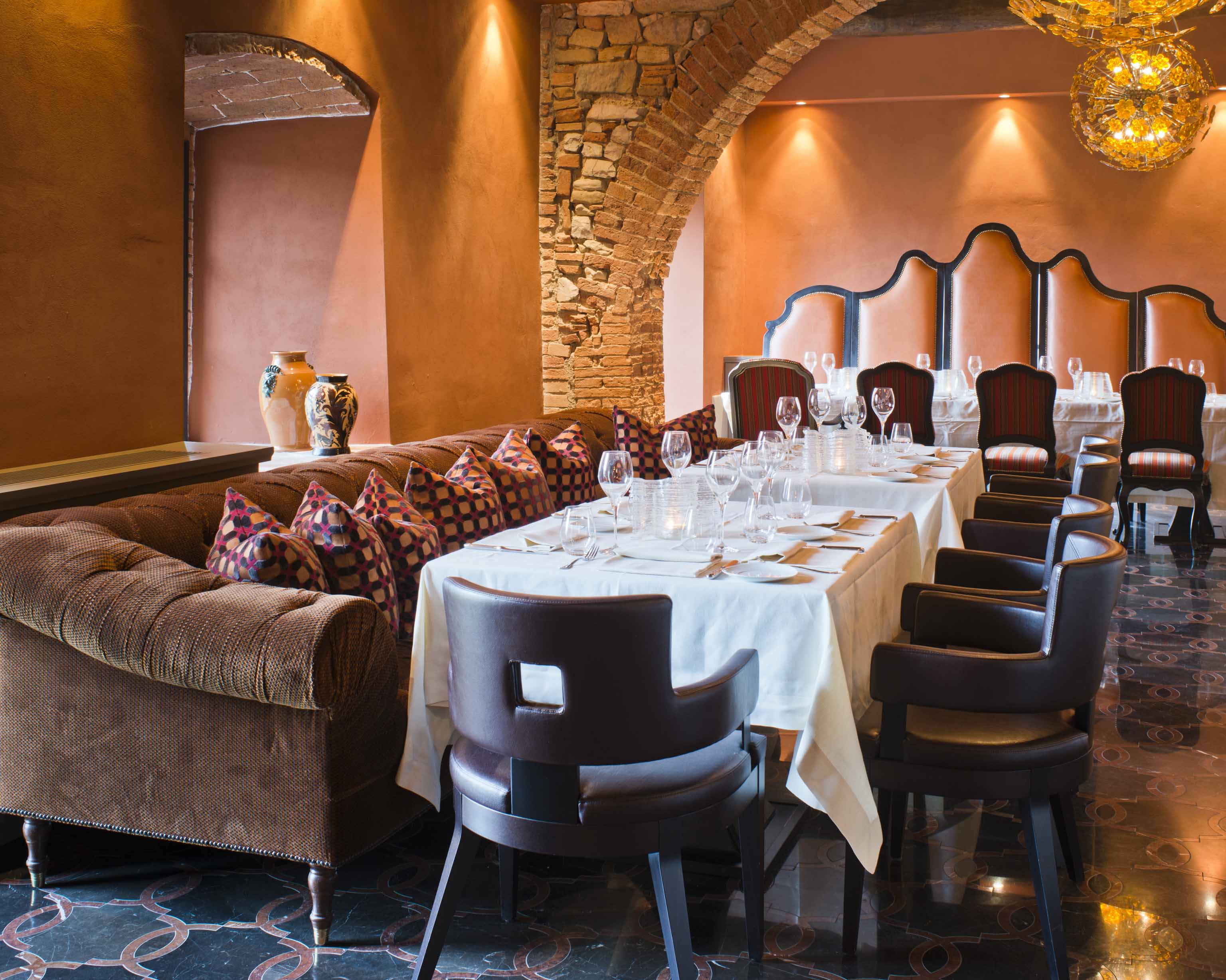 j banks design project interior design castello di casole includes warm and inviting restaurant