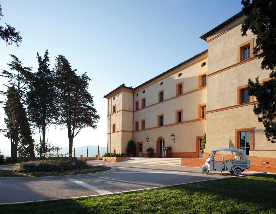 outside of hotel castello di casole illustrates the tuscan surroundings that set the tone for the interiors