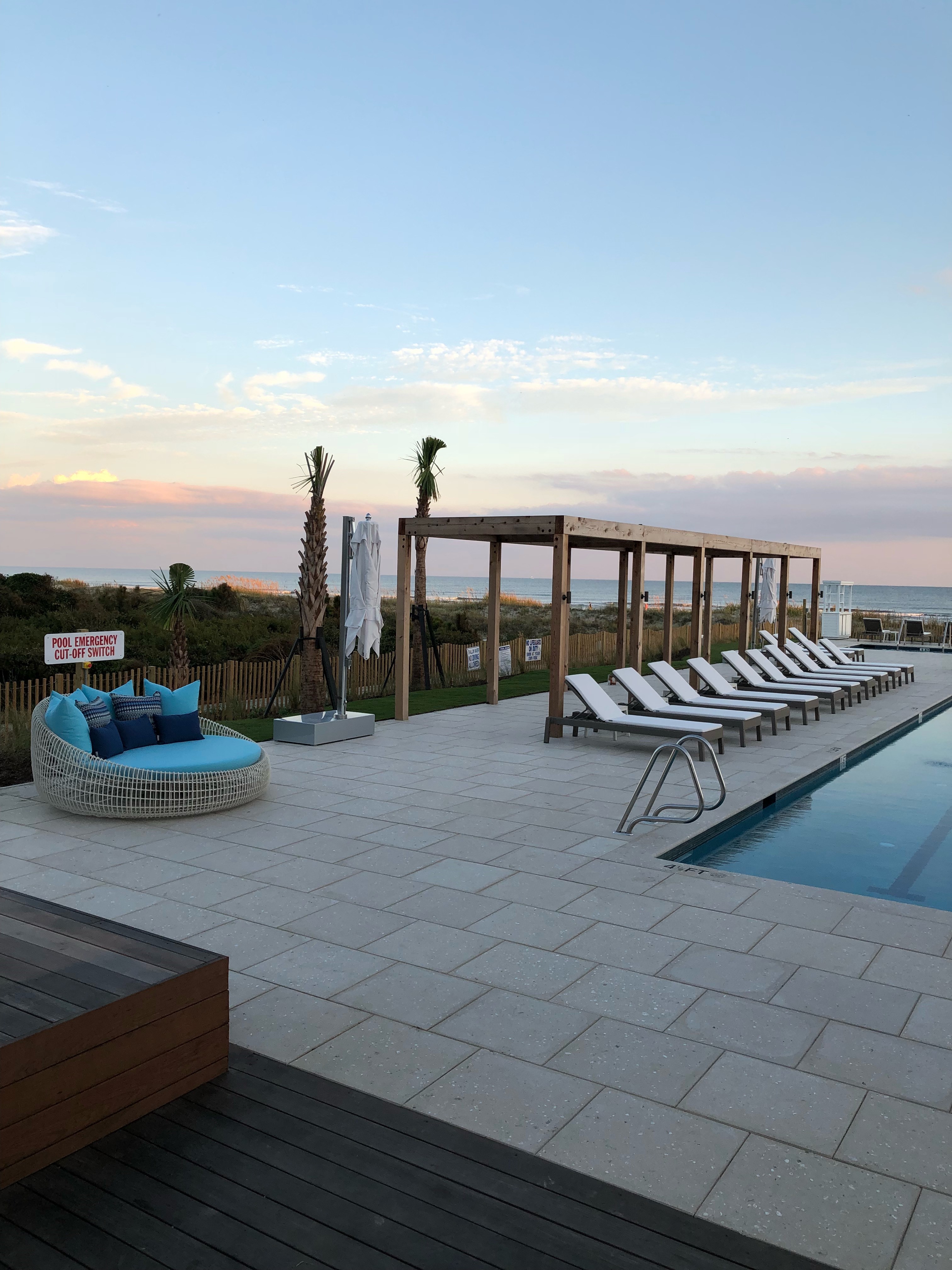 pool deck of the timbers in kiawah island with furnishings sourced by the J. Banks Design Group