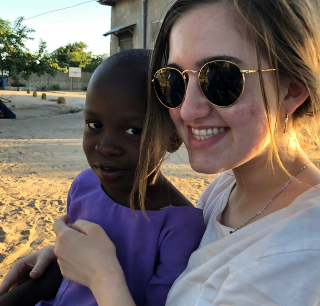 Sarah Vanderslice hugs a child at the valentine project children's home in dar es salaam tanzania