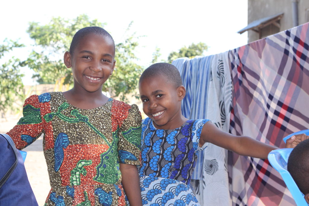 smiling girls in colorful dresses at valentine project children's home-dar es salaam, tanzania