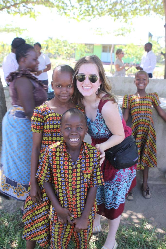 happy children hugging Sarah Vanderslice at the valentine project children's home in dar es salaam tanzania