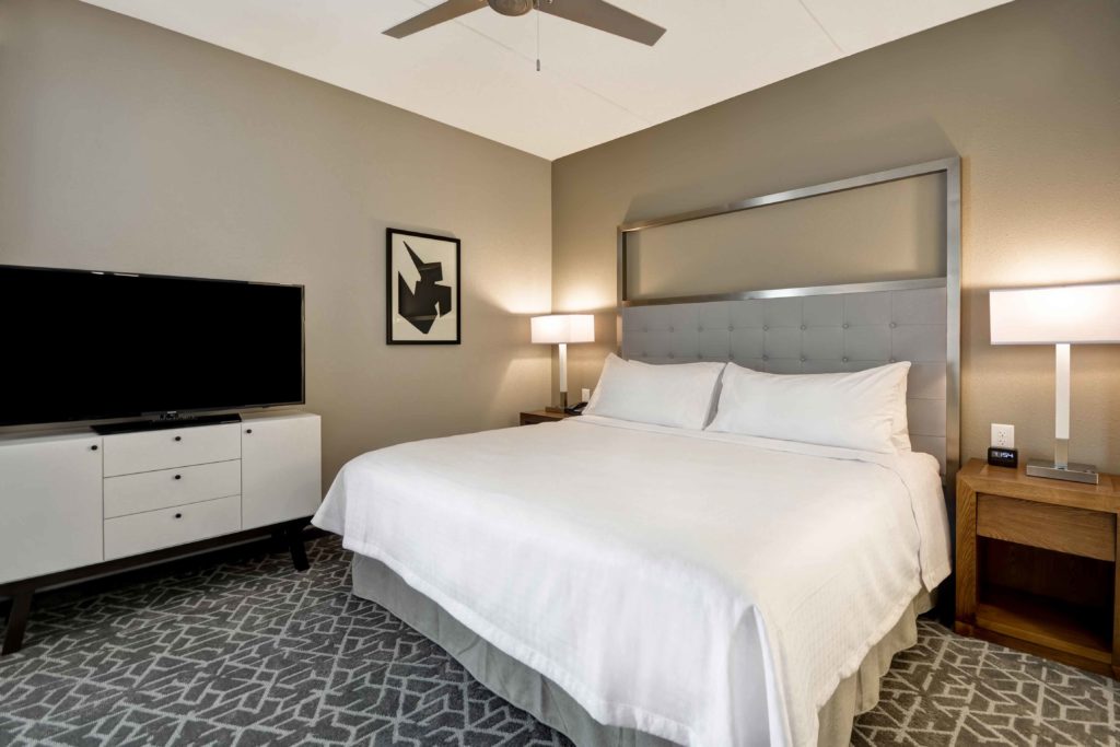 studio bedroom view at Homewood Suites in Cary, NC, designed by J Banks Design Group with a King bed