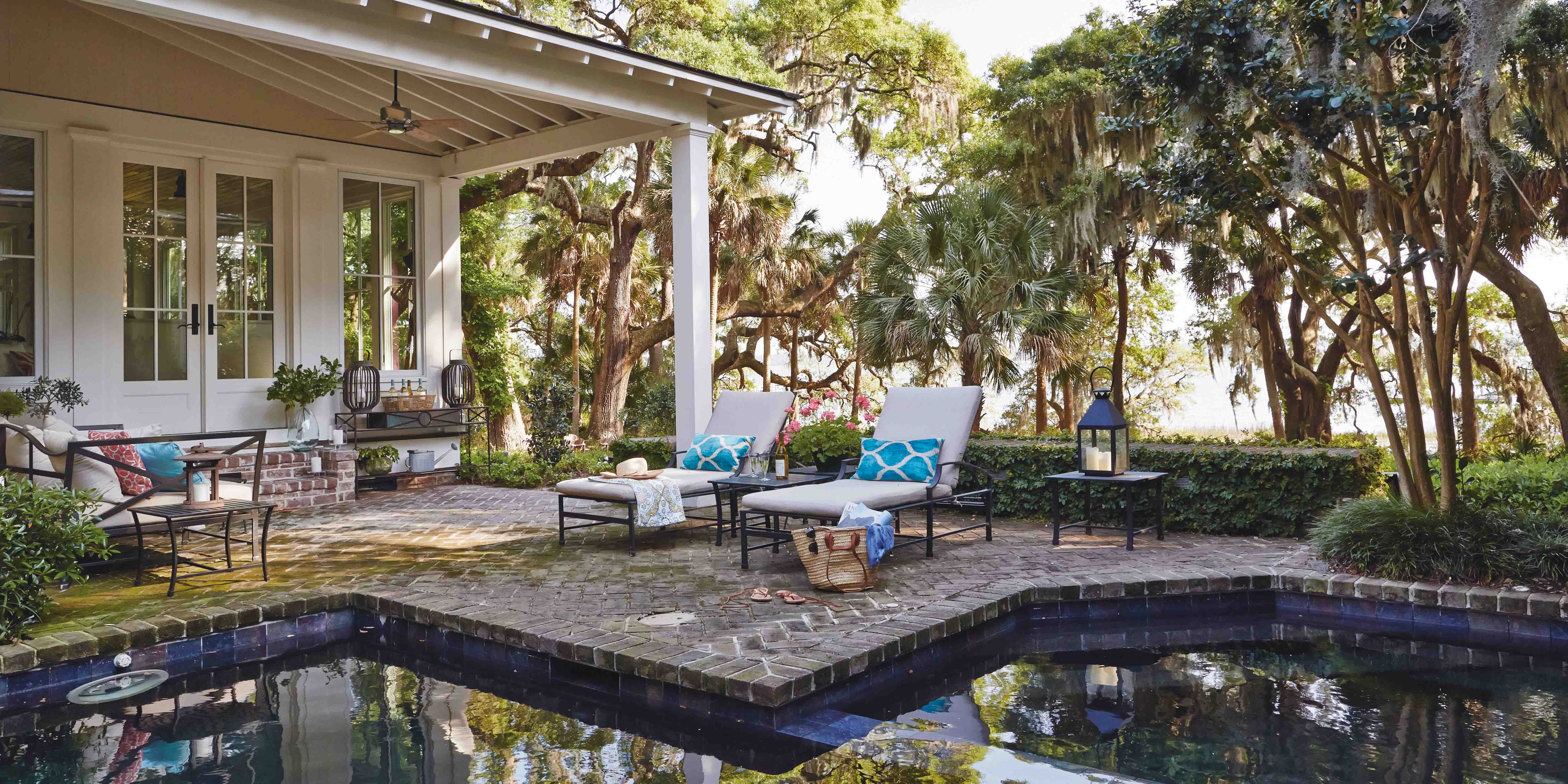 View of pool and brick patio in Palmetto Bluff designed by J Banks Design Group