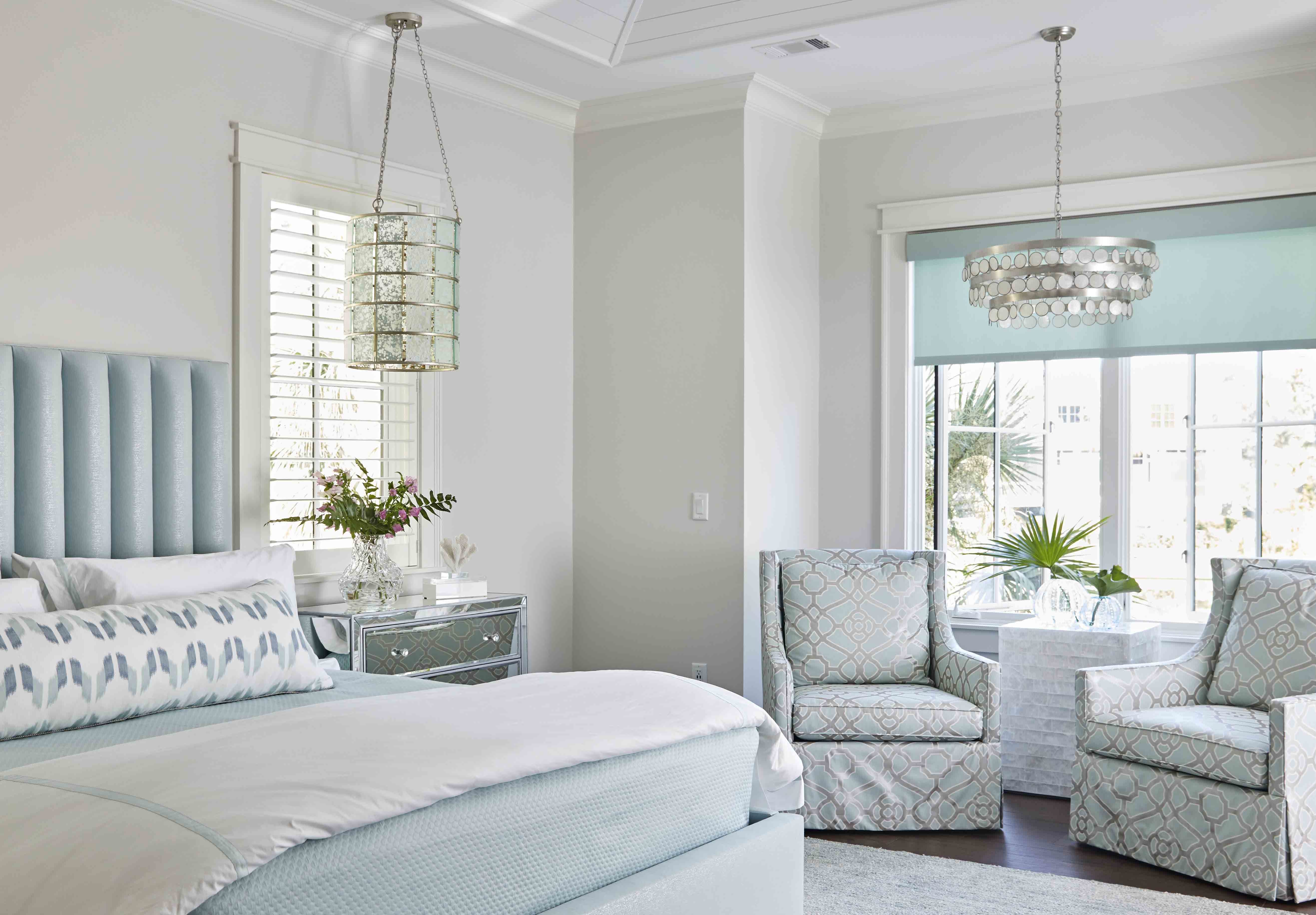 Pale blue coastal bedroom with pendant light and channel upholstered head board by Hannah Toney of J. Banks Design Group