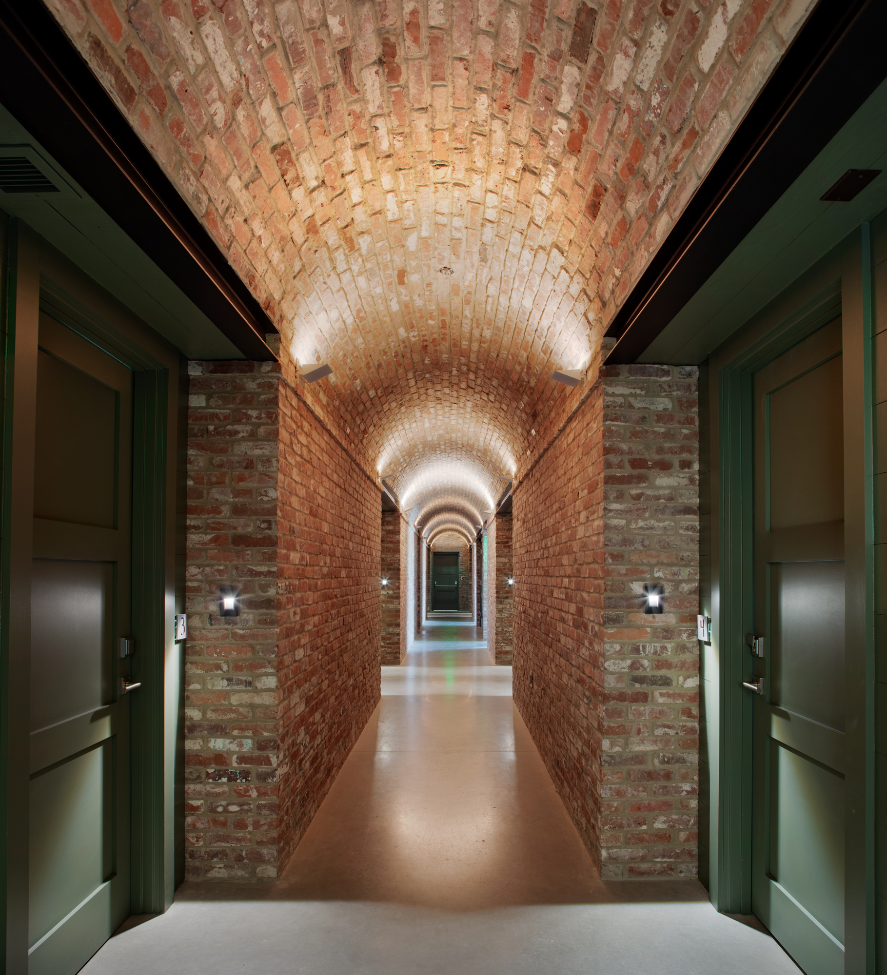 The burrow at the Ohoopee Match Club features a brick vaulted hallway with guest rooms